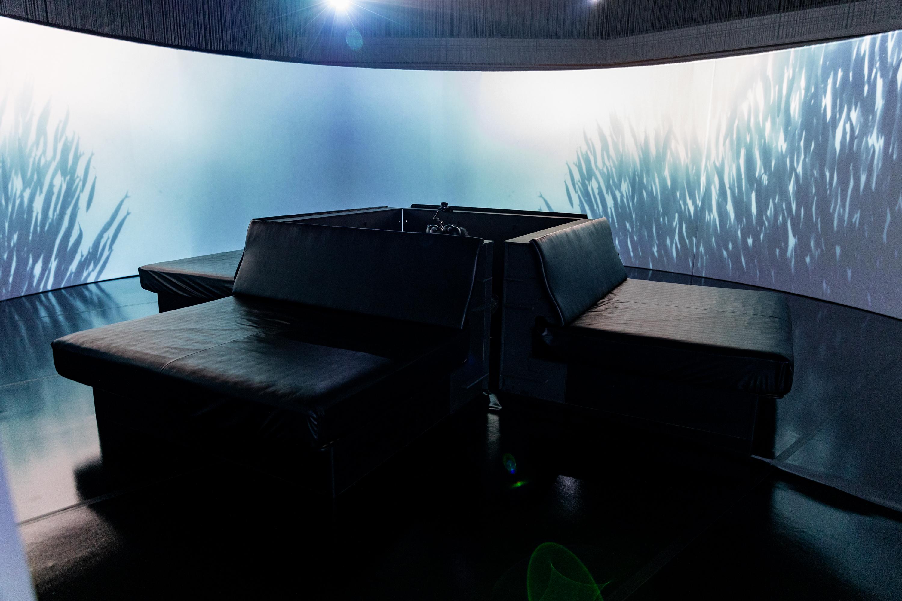A kinetic seating arrangement in front of a circular panorama projection screen driven by a Screenberry media server