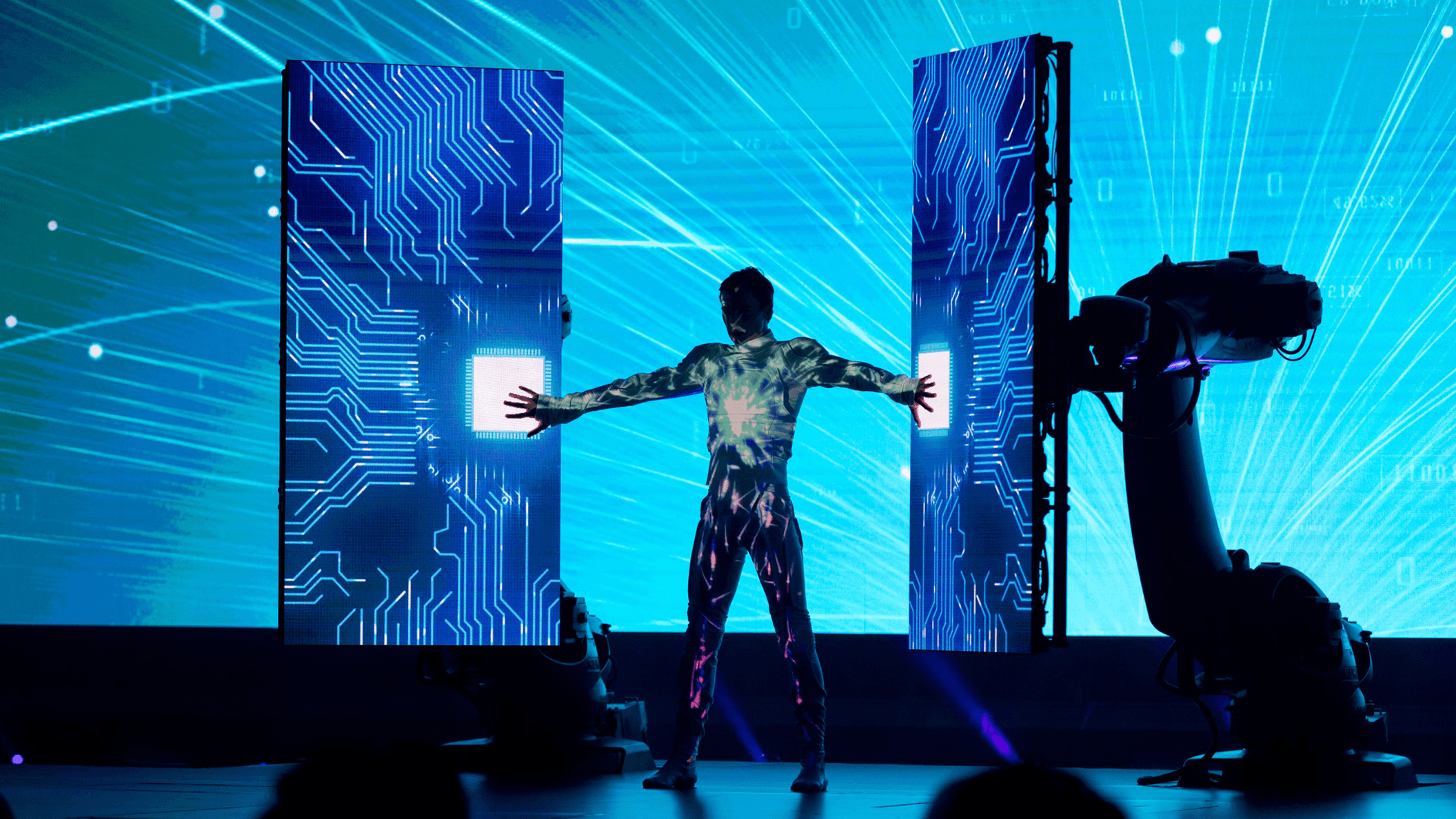 A performer interacts with LED screens during a multimedia performance at the Global AI Summit 2022