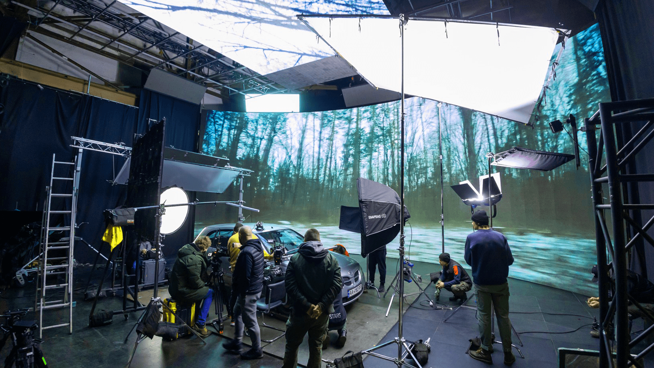 Virtual production studio with a film crew and LED screens, showcasing Screenberry's capabilities for TV and Cinema production