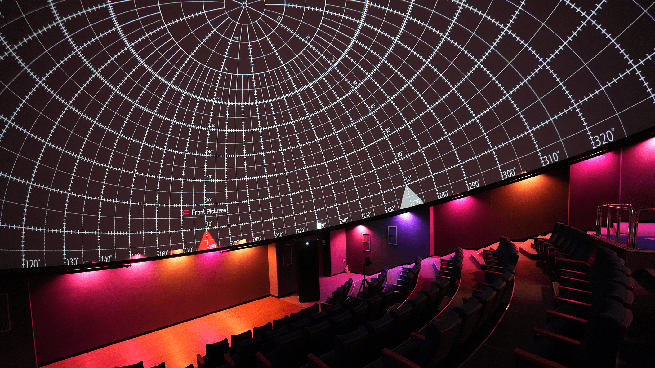 A fulldome theater with a calibration test grid showcasing Screenberry's capability for automatic warping and blending for multi-channel dome projections