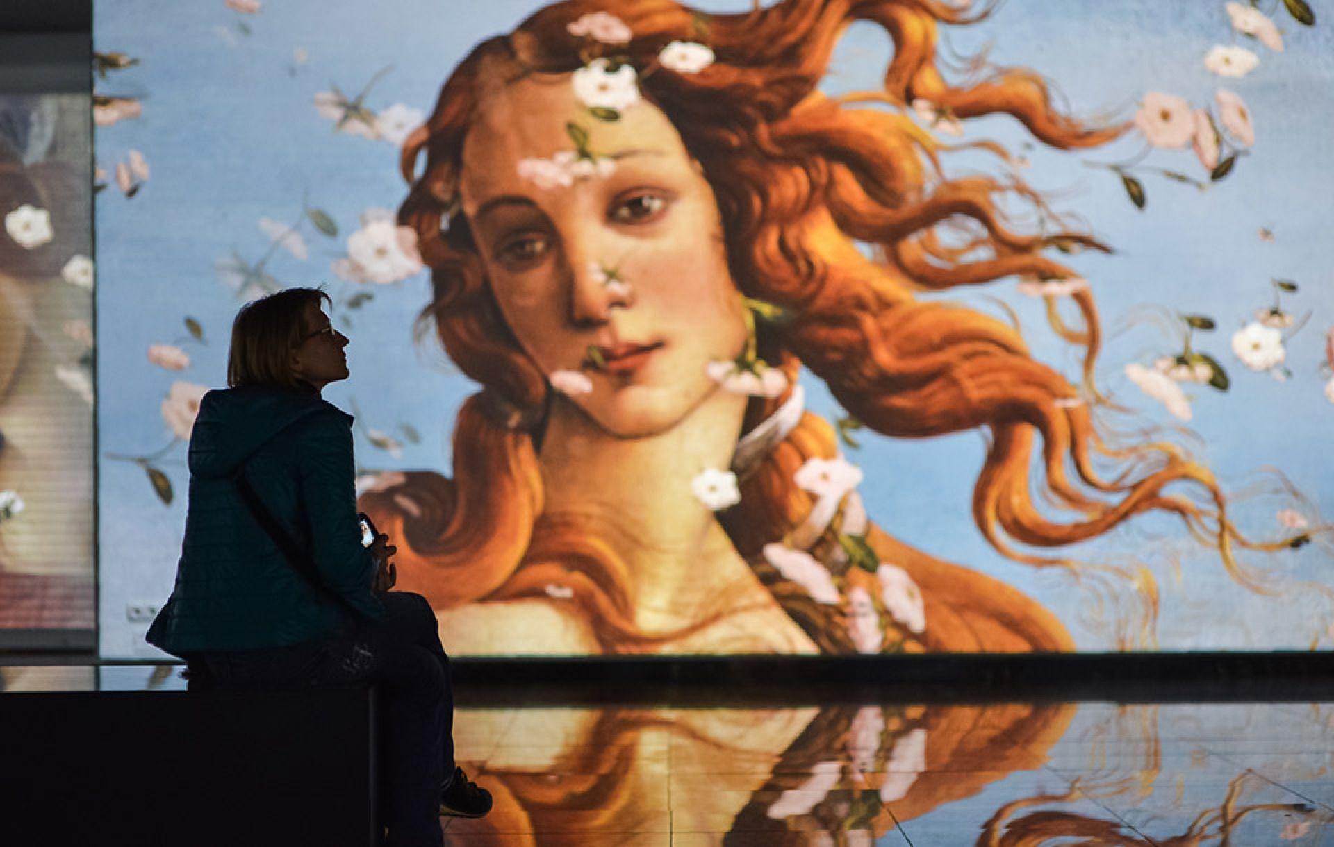 A visitor enjoying the Renaissance multimedia exhibition