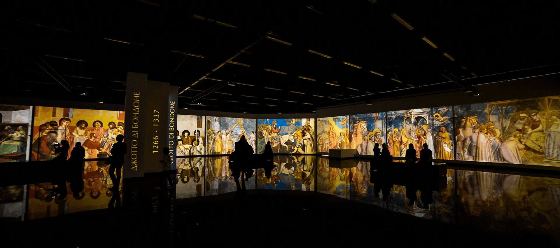 Group of visitors immersed in the Screeberry-driven projection of classical artworks at A-Gallery