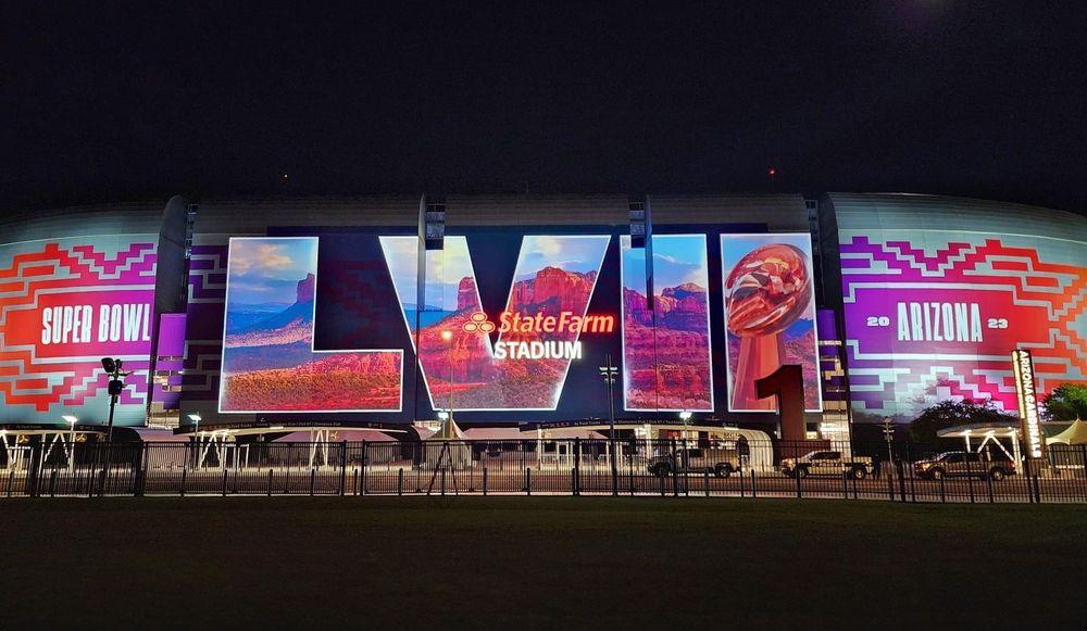 Large-scale projection mapping onto State Farm Stadium during the Super Bowl LVII