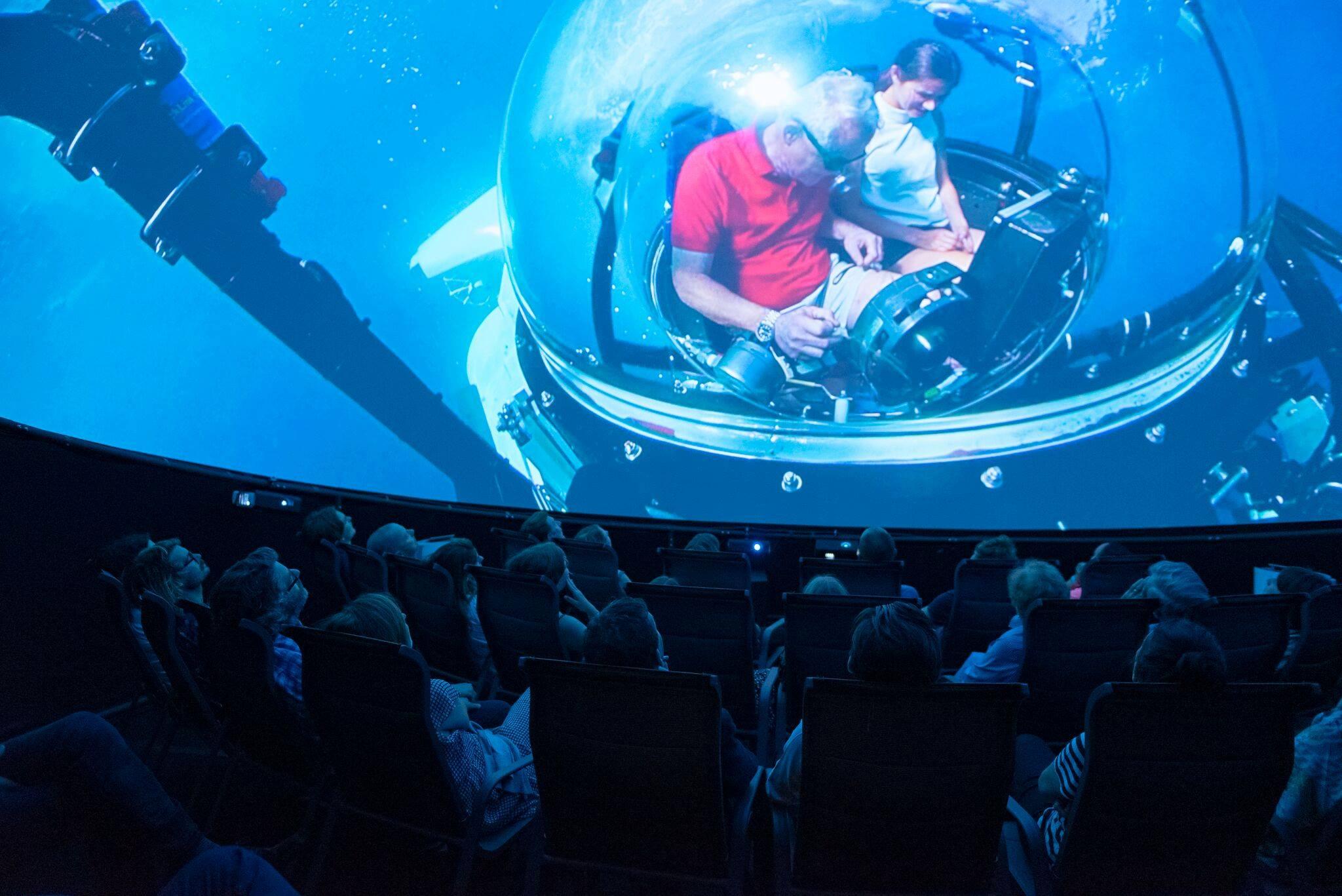 Audience watching Prospero Productions' underwater 360° movie in a touring dome theater, powered by Screenberry