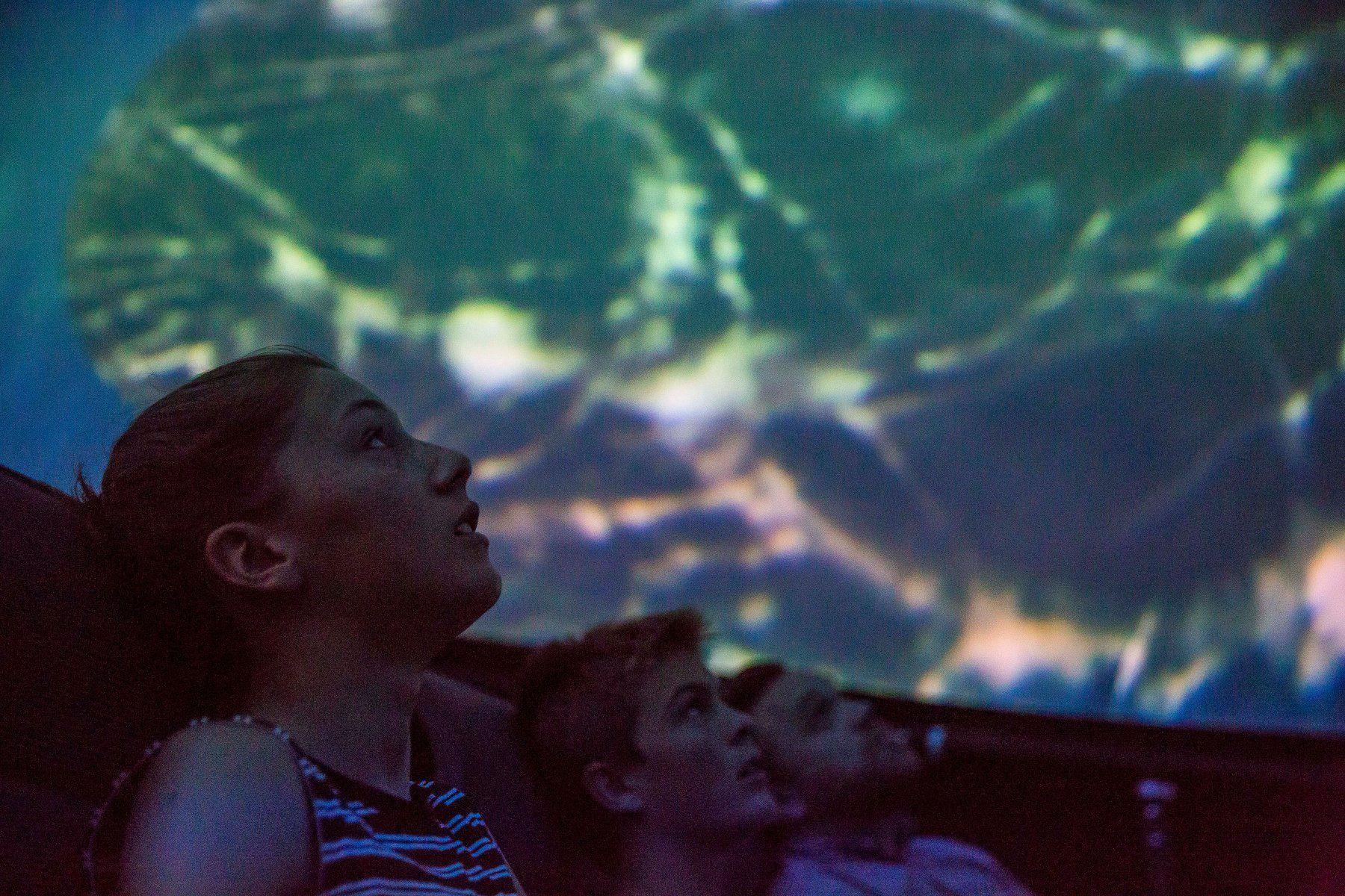 Kids watching fulldome show at a 8m mobile planetarium