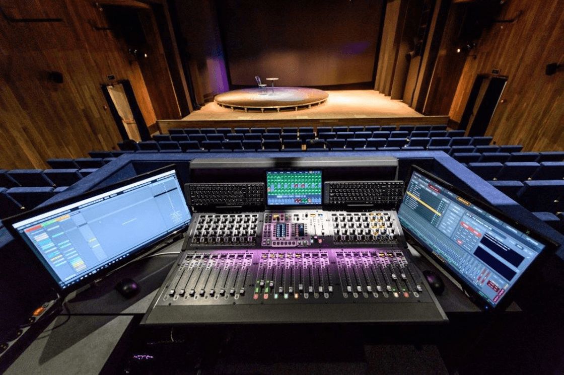 A view of the stage from Theater on Podil's front of house equipped with a mixing console and a Screenberry control panel
