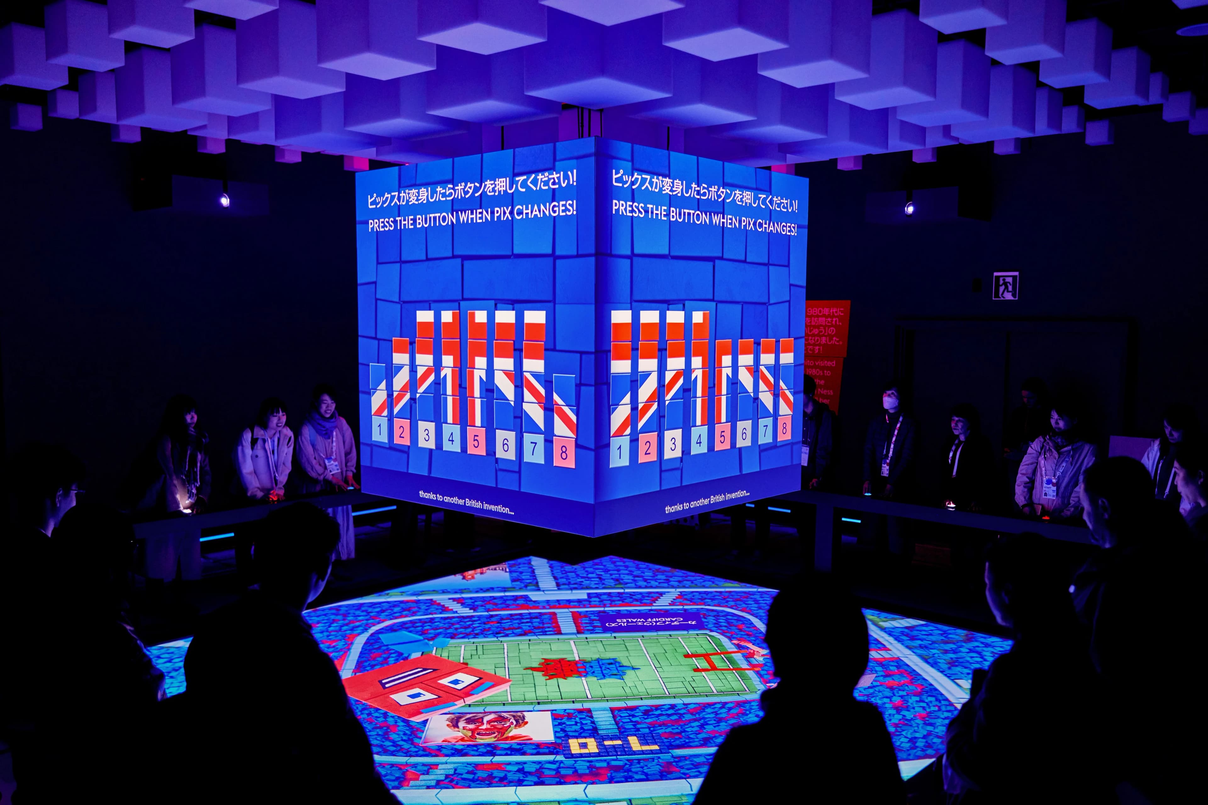 People playing a game with interactive projection mapping driven by Screenberry at the UK Pavilion, Expo 2025 Osaka.