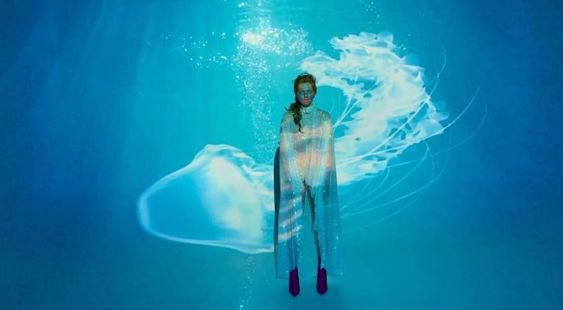 Woman illuminated by a Screenberry-powered front projection as part of Chingiz's music video at Eurovision 2019