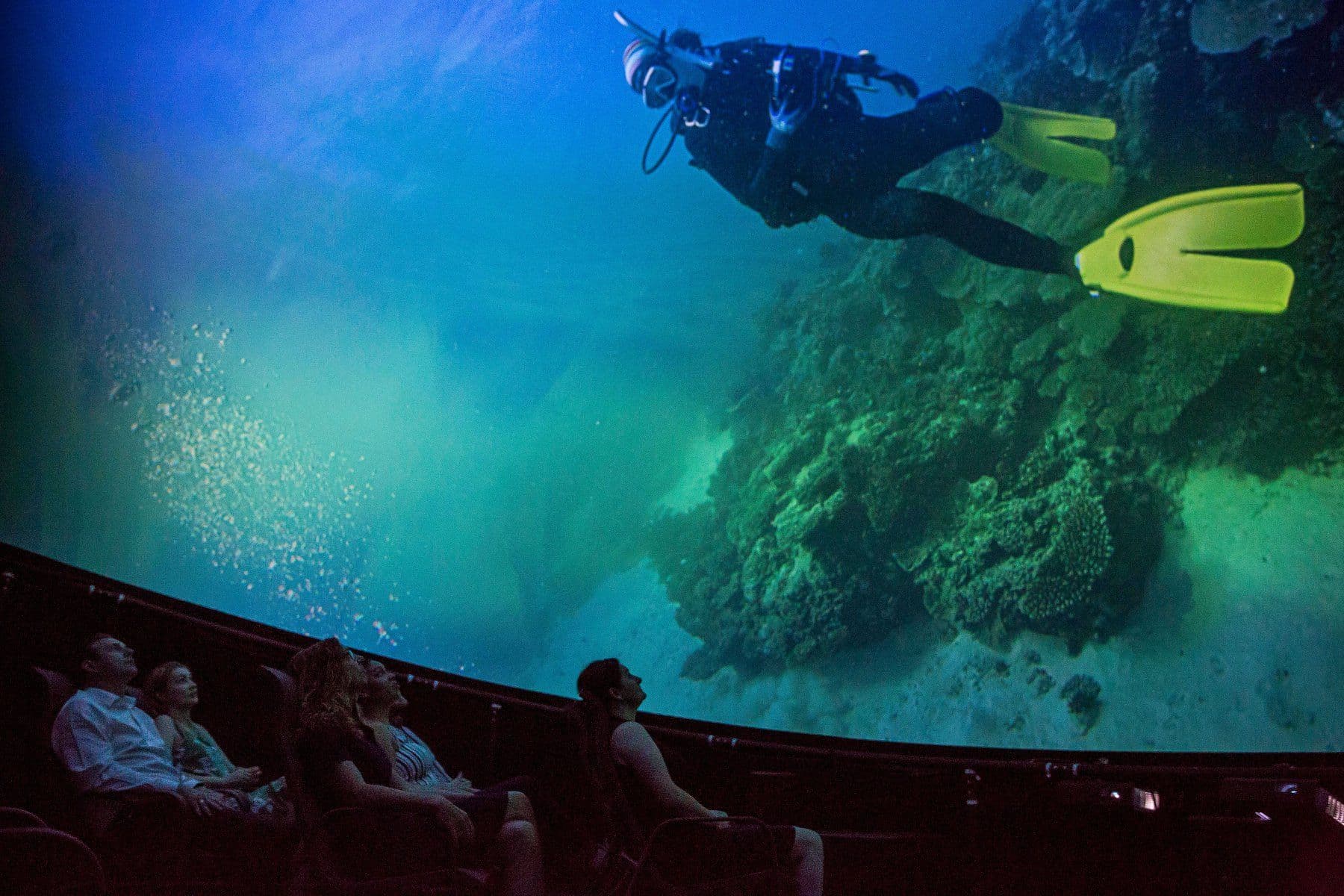 People watching 360-degree show at a mobile planetarium