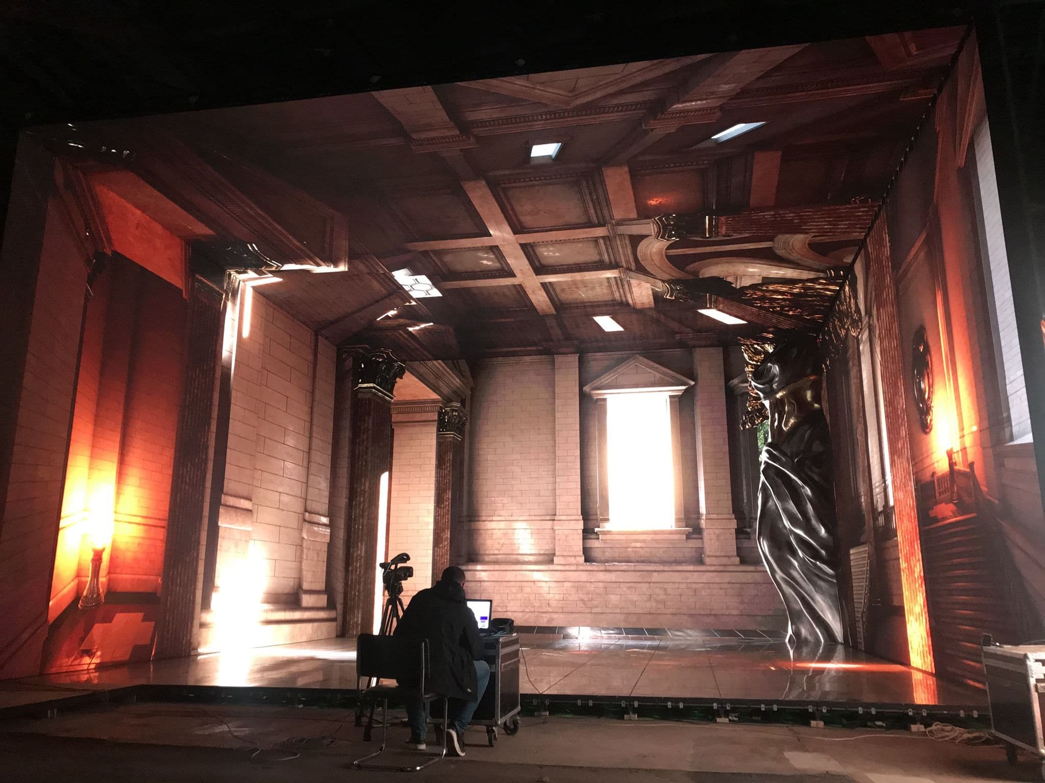 A technician setting up an LED volume in a virtual production studio